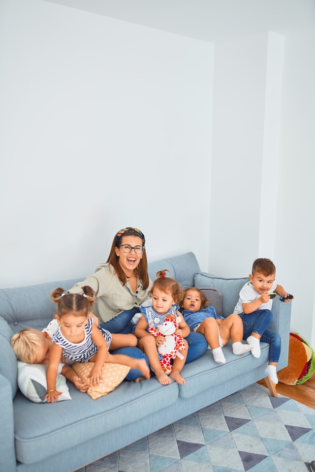 woman with many kids on a sofa